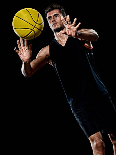 istock caucasian young basketball player manisolated black background 1215423748