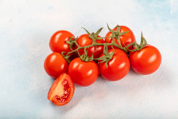 istock Fresh red ripe salad tomatoes on the vine. 1215424862