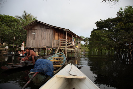 People live in floating wooden house on Amazon jungle River, Brazil