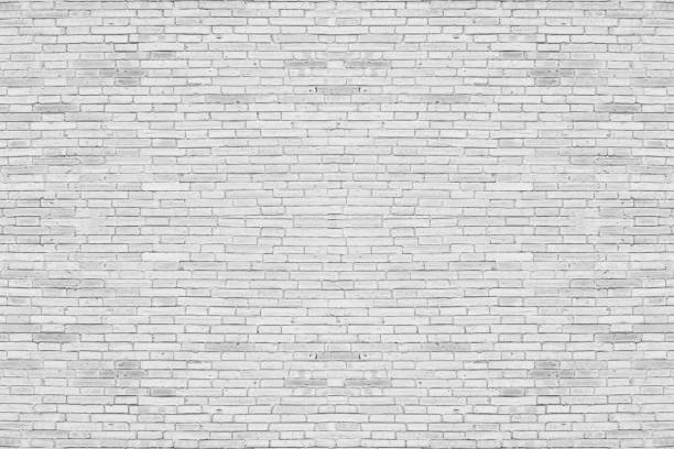 istock Abstract weathered texture stained old stucco light gray. White brick wall background in rural room. Texture horizontal wallpaper. 1215430231