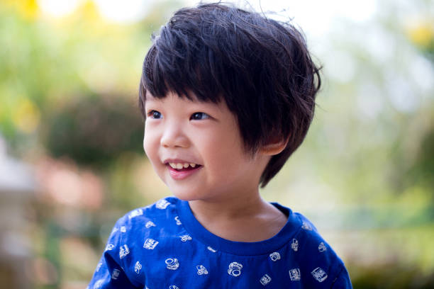 istock Cute little Asian boy with natural background 1215431223
