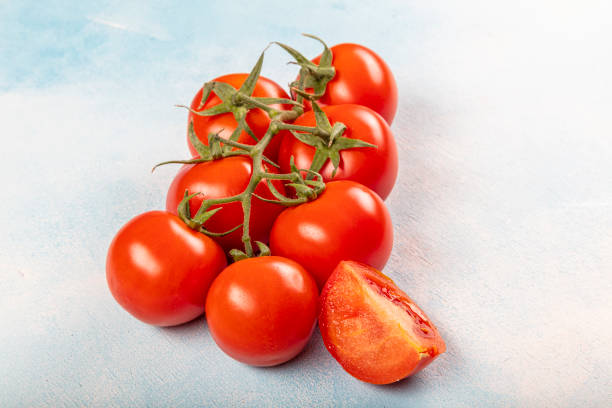 istock Fresh red ripe salad tomatoes on the vine. 1215431836