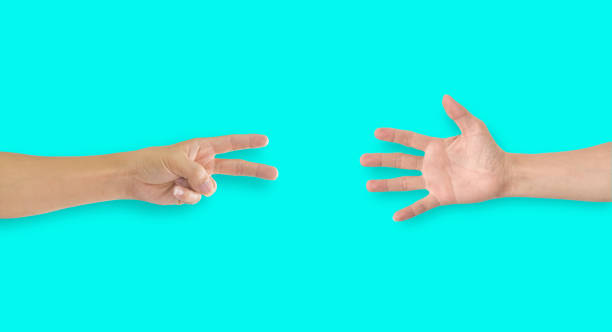 istock Two hands playing rock-paper-scissors on blue background 1215433852
