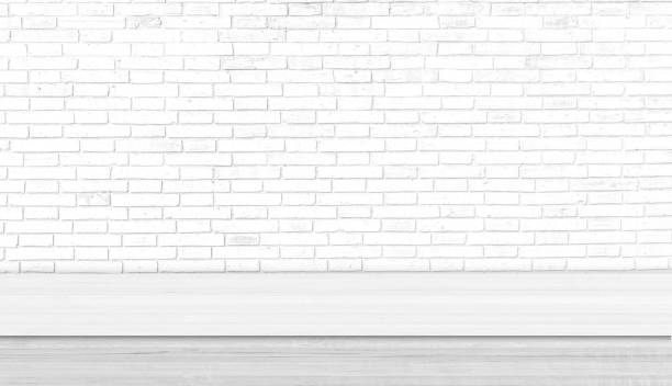 istock White wood table studio with white brick wall. Background for advertise product or web banner. 1215433866