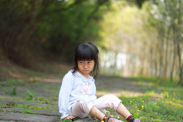 istock a Asian girl running in a forest. 1215434515