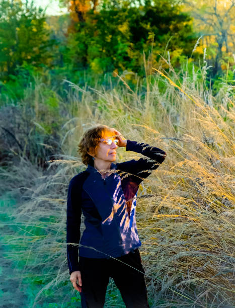 istock Senior woman looking at setting sun in Midwest 1215440961