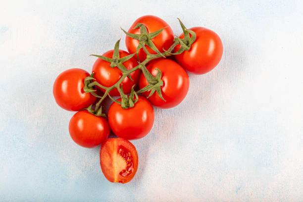 istock Fresh red ripe salad tomatoes on the vine. 1215442222