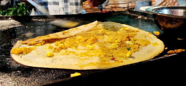 istock A Dosa is a cooked flat thin layered rice batter, originating from the South India, made from a fermented batter. Main ingredients are rice, black gram 1215443149
