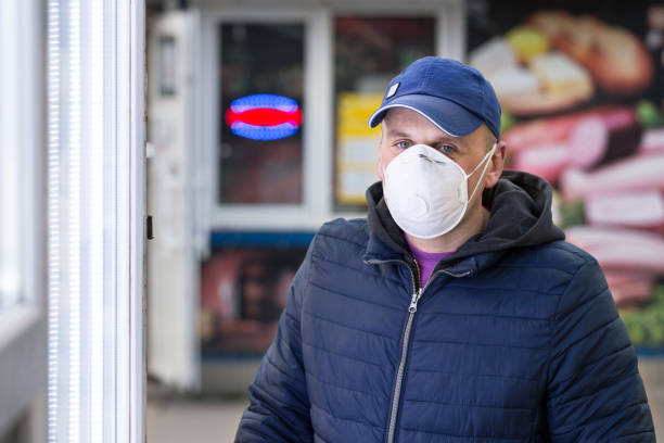 istock Man in a protective mask with a valve on the street. 1215444036