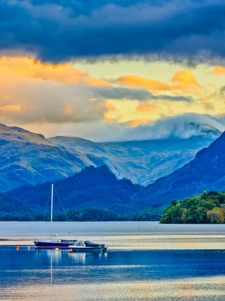 The Lake District region of the United Kingdom View of Derwentwater with moored sailboats at sunset in the Lake District in the United Kingdom keswick photos stock pictures, royalty-free photos & images