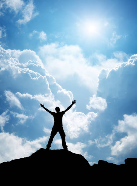 istock Man enjoy to the sun and sky clouds 1215445227