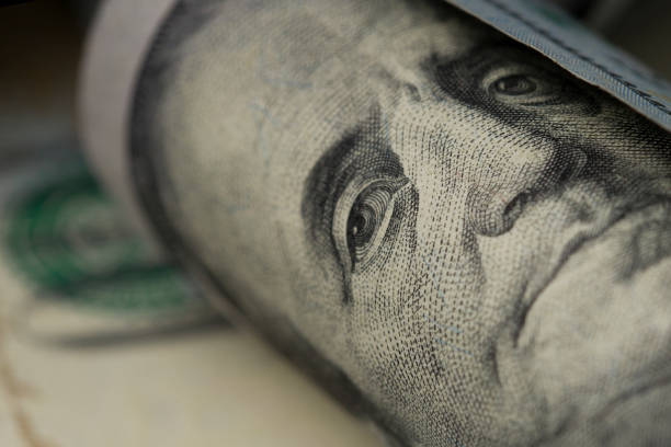 istock Benjamin Franklin portrait rolled up . Close up 1215446280