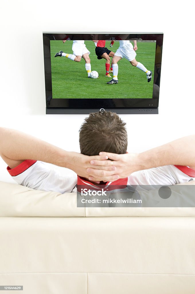 Człowiek oglądania meczu w telewizji - Zbiór zdjęć royalty-free (Oglądać telewizję)