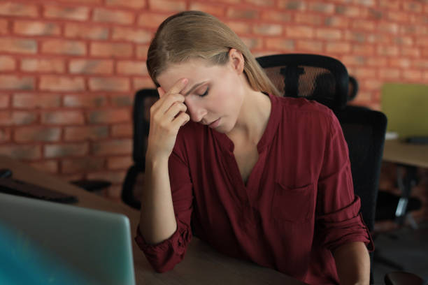 istock Frustrated business woman looking exhausted while sitting at her working place 1215448748