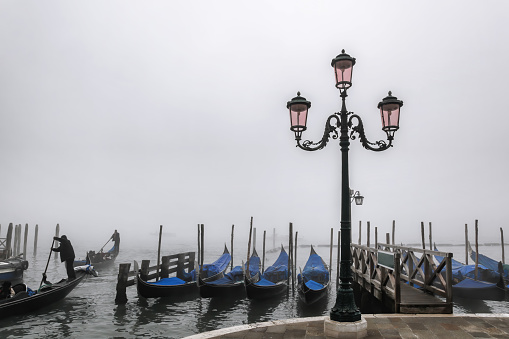 Venice with gondolas against foggy day in Italy