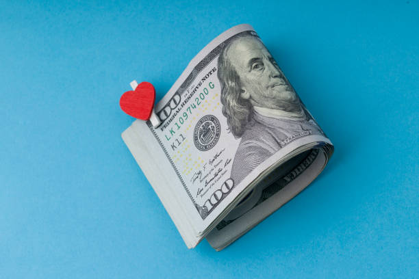 U.S. one hundred  dollars with the symbol of the heart on blue background. Close up U.S. one hundred  dollars with the symbol of the heart on blue background. Close up valentinstag stock pictures, royalty-free photos & images