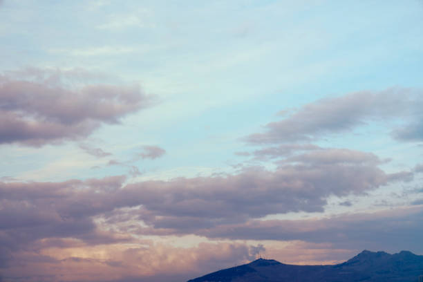 yellow and orange clouds at sunset. dramatic sky skyline background with mountain