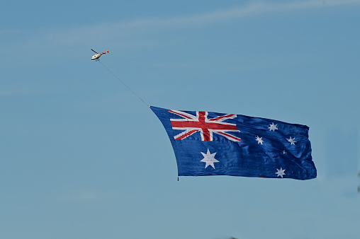 The national flag of Australia flying in the sky on Australia Day celebrations.