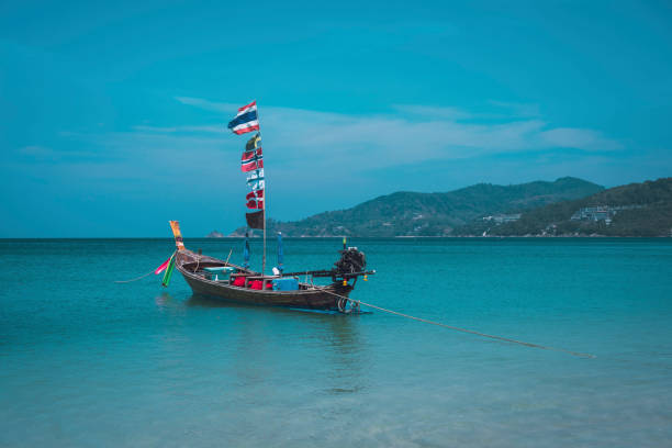 A long tail boat seen at Patong Beach in Phuket, Thailand, during a hot summer day in the tropics.