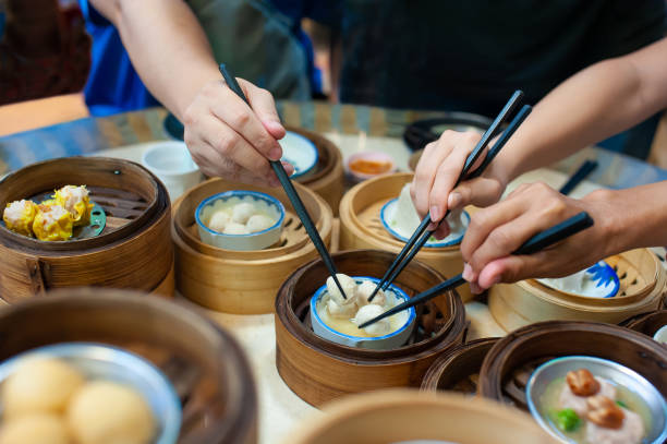 Using chopsticks to eat dim sum Eating dim sum the Chinese way by using chopsticks, Thailand traditional malaysian food stock pictures, royalty-free photos & images