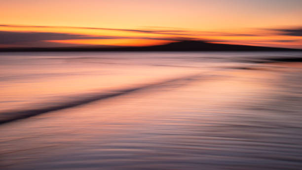 istock A tranquil seascape of the Milford beach at sunrise. Image made using intentional camera movement technique. 1215457075