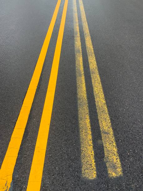 istock Double Yellow Line Painting 1215459322