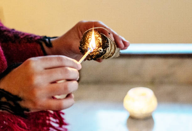 woman burning white sage incense , shaman - fire match women flame imagens e fotografias de stock