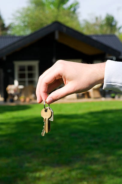 istock Real estate agent shows keys to new home 121545954
