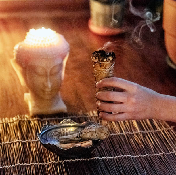 istock Woman burning white sage incense , shaman 1215459660