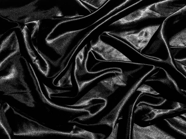 istock luxury black silk or satin texture background with liquid wave or wavy folds. Wallpaper design 1215460826