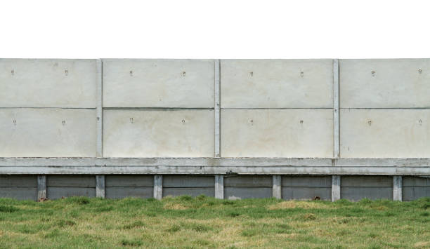 istock Factory concrete fence on green grass 1215461453