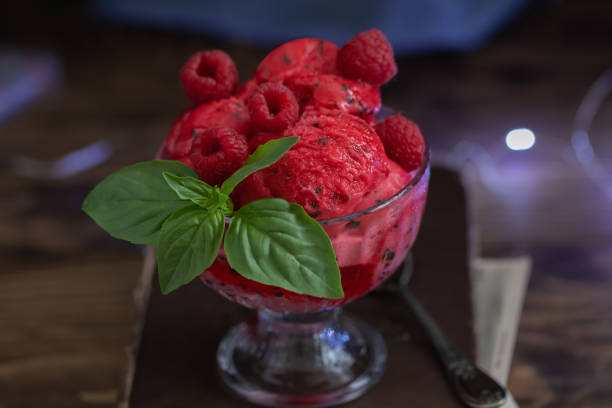 istock Raspberry and basil homemade ice cream, summer sundae with fresh berries on rustic background, close up, selective focus 1215461492
