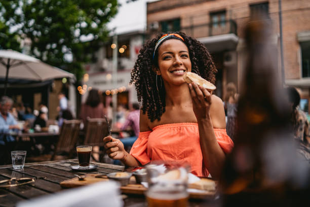 Young woman at sidewalk cafe eating