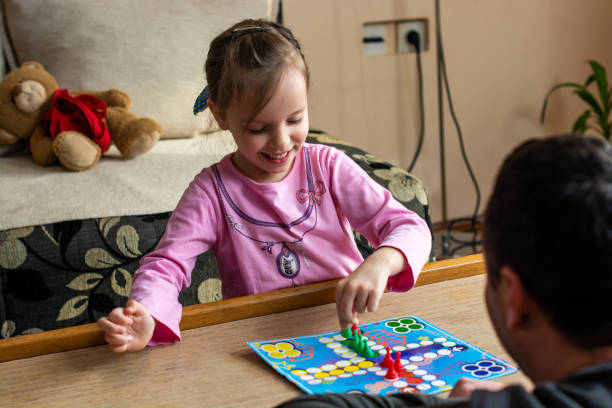 istock Family playing board game at home 1215464226