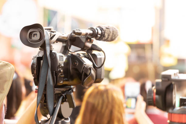 istock Professional digital video camera technician. Videographer with equipment at event. 1215465262