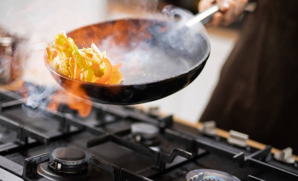 istock Professional Chef Tossing Food 1215465438