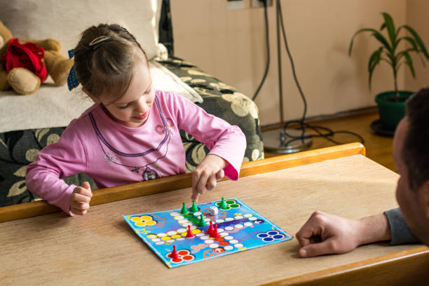 istock Family playing board game at home 1215465469