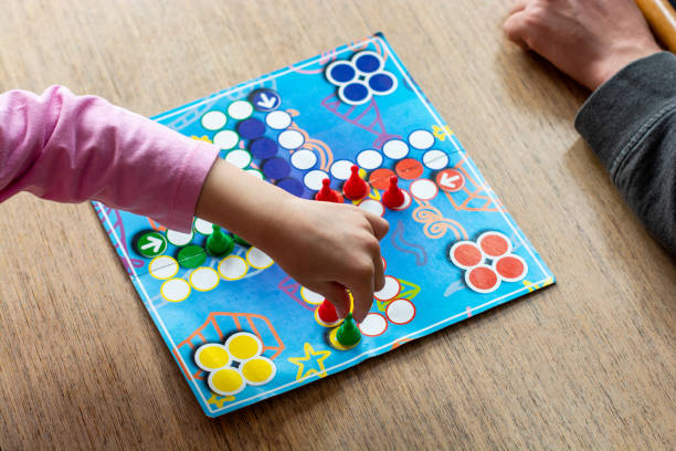 istock Family playing board game at home 1215465863