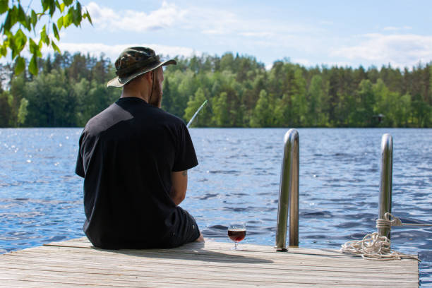 istock Mature man fishing from pier 1215466484