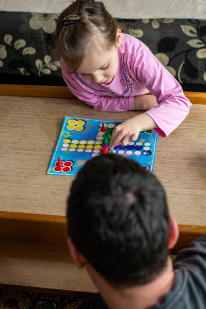 istock Family playing board game at home 1215466965