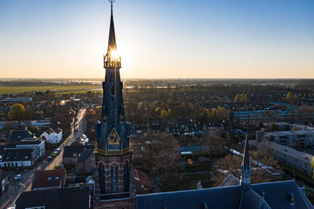 A church during sunrise on a sunny morning in the dutch town of Waalwijk, Noord Brabant, Netherlands A church during sunrise on a sunny morning in the dutch town of Waalwijk, Noord Brabant, Netherlands berkel stock pictures, royalty-free photos & images