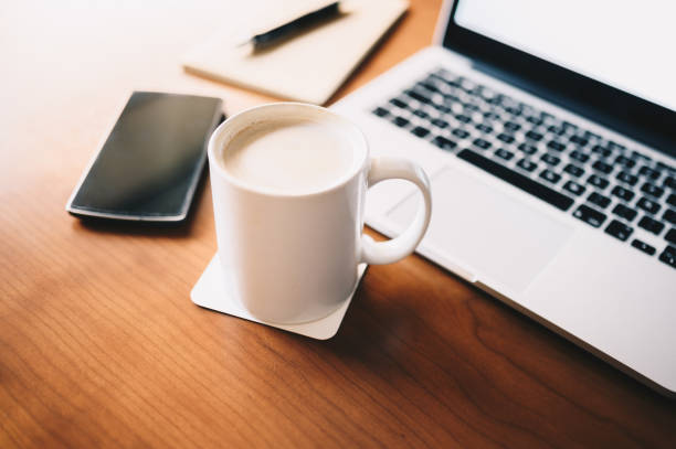 istock Classic workplace with a cup of coffee laptop and notebook 1215469089