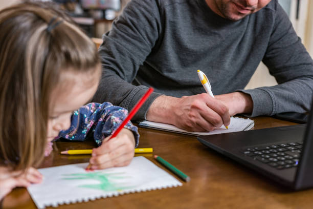 istock Father working from home with young child in quarantine isolation 1215470282