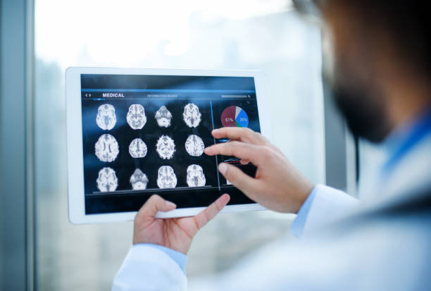 istock Unrecognizable doctor with tablet standing in hospital, working. 1215471883