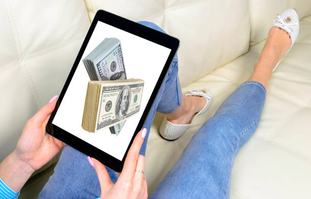 istock Make money online. Business concept with making profit using internet. Laptop computer with money in woman hands. Making money online concept. Using a laptop to building online business 1215472033