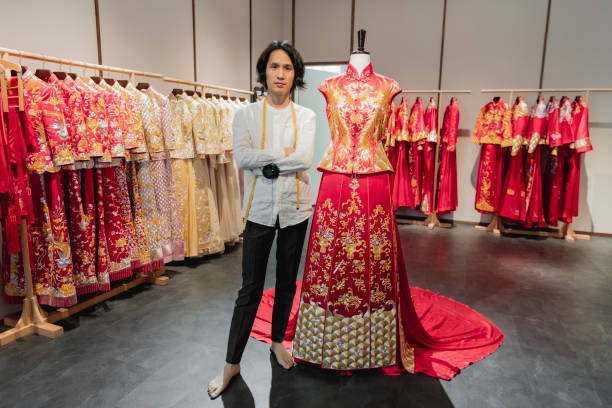 istock Traditional Chinese wedding dress designer in his studio 1215473052