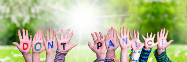 istock Children Hands Building Word Do Not Panic, Grass Meadow 1215474030