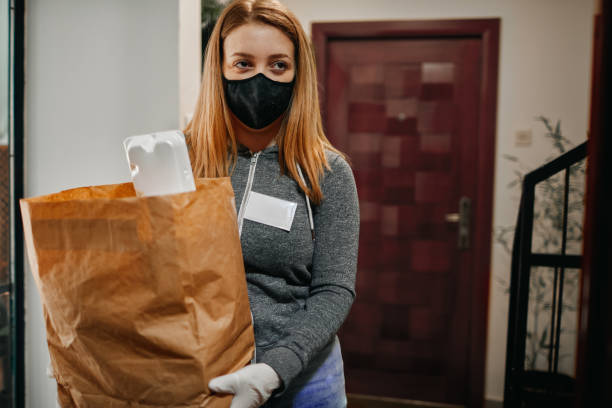 istock Volunteer Delivering Food To Elderly People During Lockdown 1215474664