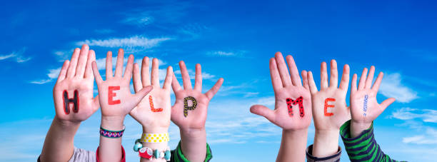 istock Children Hands Building Word Help Me, Blue Sky 1215474879