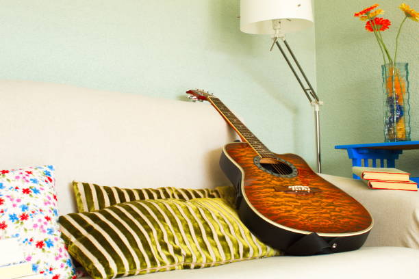 istock Reading an interesting novel in a comfortable chair or learning how to play the guitar 1215476006